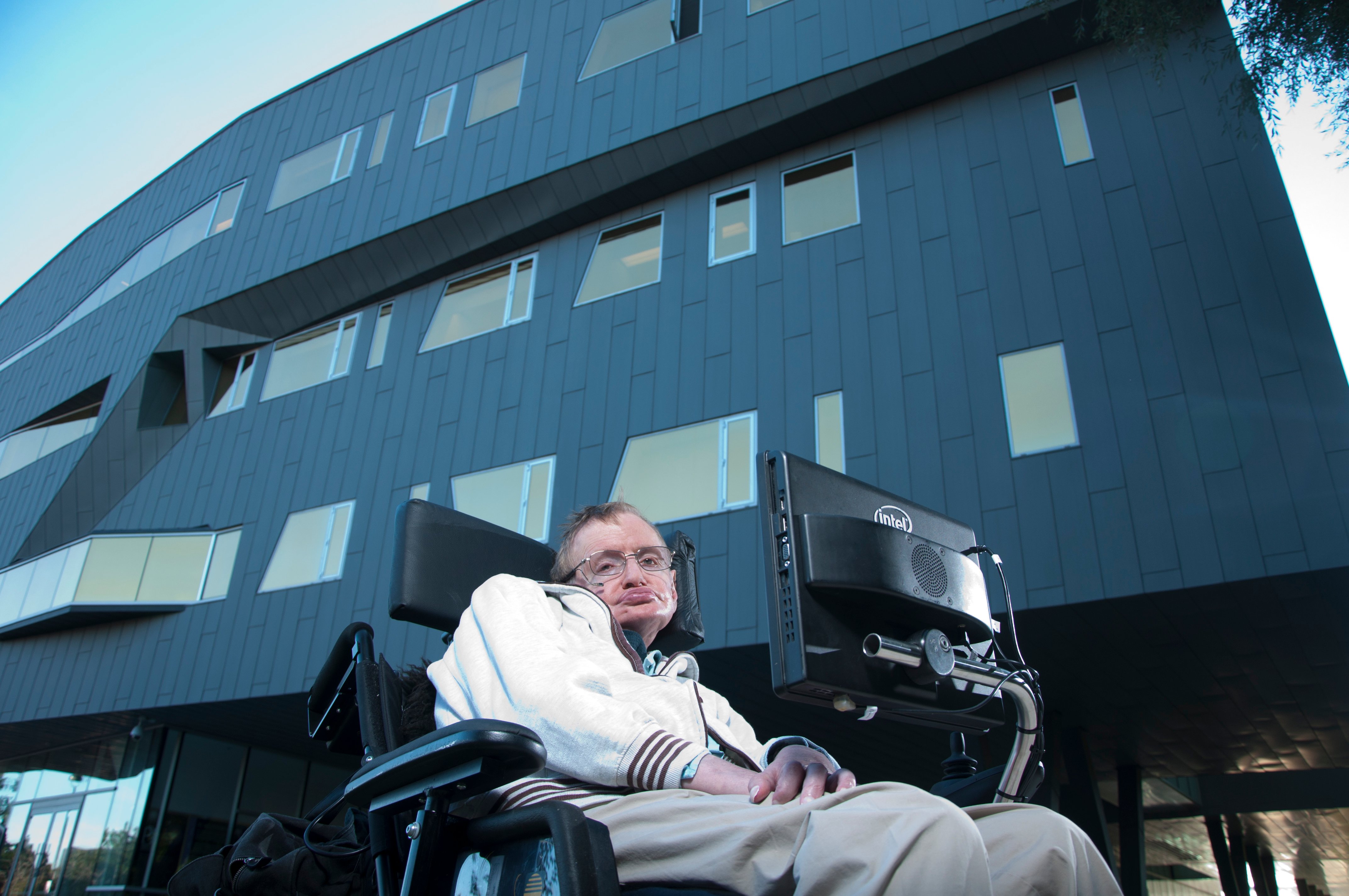 Stephen Hawking in front of the facade of Perimeter Institute